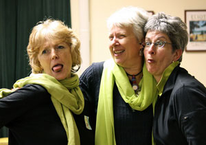 Three women wearing black and lime green